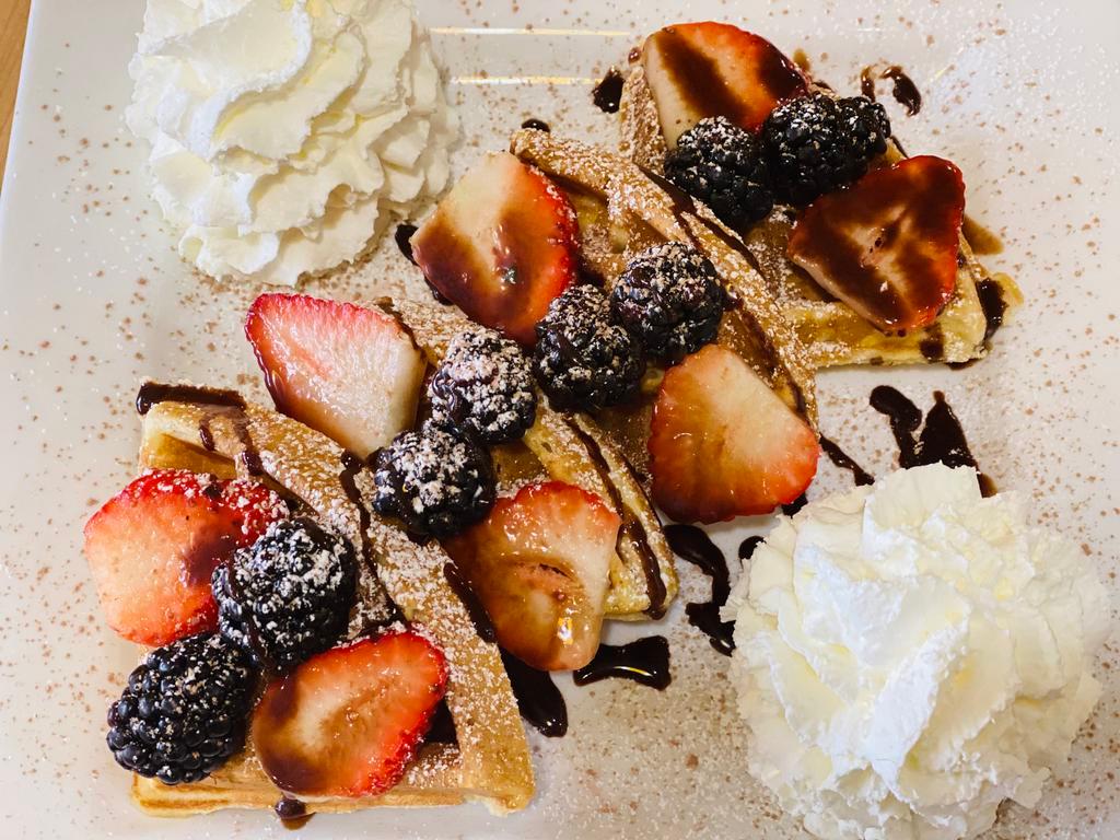 Easiest Belgian Waffles · Waffles topped with strawberries, blackberries and blueberries, drizzled with hershey chocolate syrup, dusted with sugar and chocolate powdered, sided with whipped cream