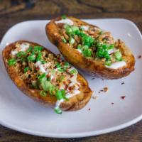 Loaded Potato Skins · A single potato, cut in half and loaded up with crispy tempeh bacon, melted cheese, sour cre...