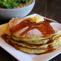 Happy Home Pancakes (Gluten-free) · Three golden pancakes served with agave maple syrup and butter