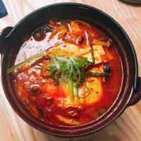 Soft Tofu Stew Soup · Spicy stew cooked with squid, shrimp, silken tofu, zucchini, and onions with a drop of raw e...