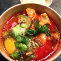 Soft Tofu Stew Noodle · Spicy stew cooked with squid, shrimp, silken tofu, zucchini, and onions with a drop of raw e...