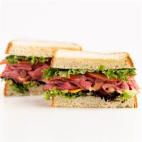 Steak 'n Cheddar Sandwich  · Sink your teeth into this . . . Chomp! This sandwich features mounds of juicy Carved Prime R...