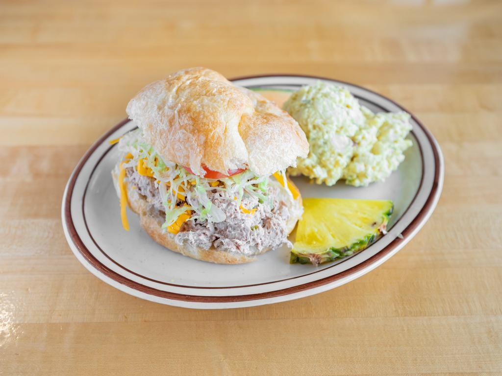 Le Tuna Croissant · Light chunk tuna salad stuffed in a croissant, sprinkled with shredded cheese, shredded lettuce and tomatoes. Served with choice of 1 side.