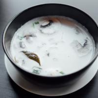 S2. Tom Kha Soup · Coconut broth soup with mushrooms and galangal.