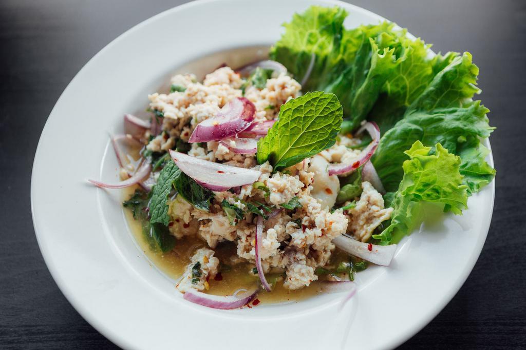 Y9. Larb Tofu Salad · Steamed tofu, red onions, mint, scallions, cilantro, ground toasted jasmine rice, and chill lime dressing. Vegan. Spicy.