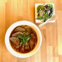 Bun Bo Hue Spicy Beef and Pork Soup · Beef, pork, pork roll sausage, noodles, scallions, yellow onions, and fresh herbs.