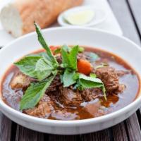 Bo Kho Beef Stew · Braised beef shank, onions, carrots, and French baguette.