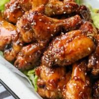 Chicken Wings with Garlic Sauce · Cooked wing of a chicken coated in sauce or seasoning.