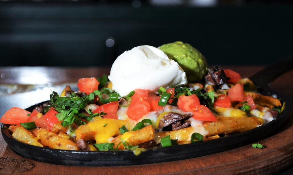 Carne Asada Fries · French fries, carne asada steak, and melted cheese. Served with guacamole, pico de gallo and beans.
