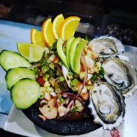 Molcajete de Mariscos · Shrimp, Scallops, Fish, Octopus, Crab, Oysters with onions and peppers in our zesty sauce. S...