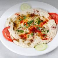 Hummus · A delightful dip of garbanzo beans, tahini, garlic, lemon juice, and olive oil. Served with ...