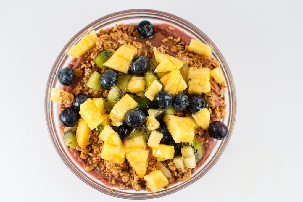 Tropical Acai Bowl · Tropical blend of organic acai, pineapple, mango, banana and coconut water blended - topped with granola, pineapple, blueberry, kiwi & your choice of honey or agave.