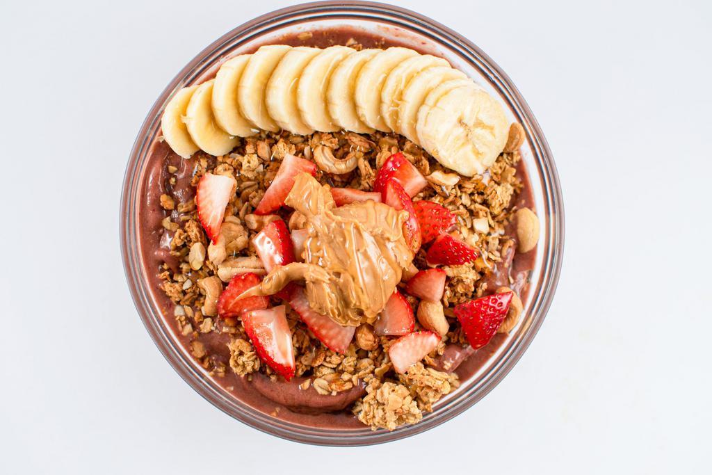 Protein Power Bowl · Protein packed blend of strawberry, banana, raw cocoa powder, protein powder (whey or plant based available) and almond milk - topped with banana, strawberry, cashews, granola, natural peanut butter and your choice of honey or agave.