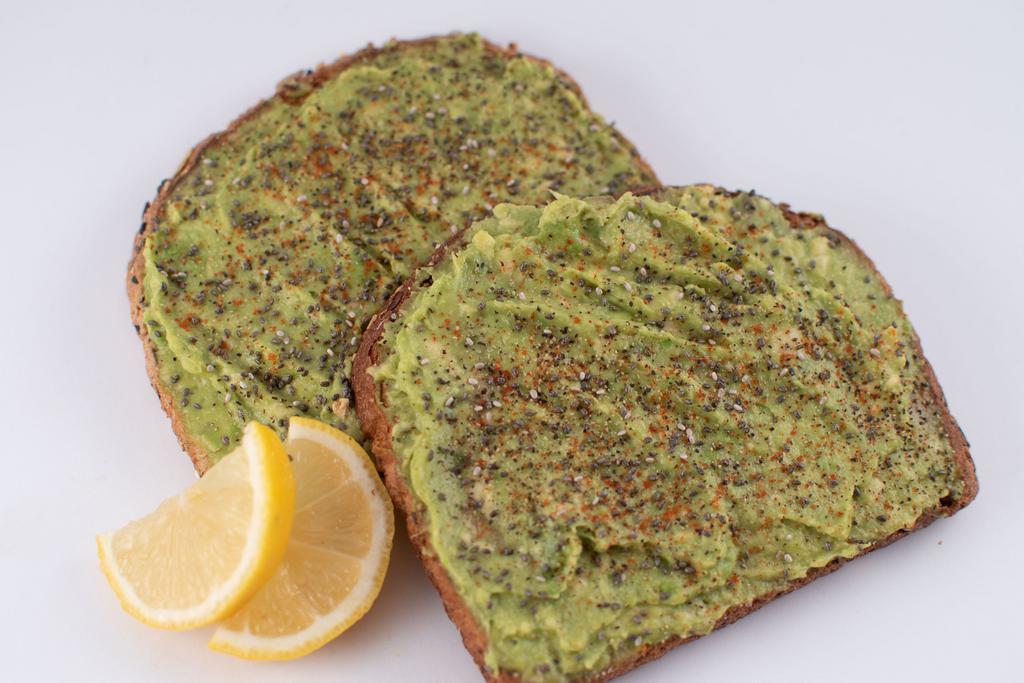 Avocado Toast · 2 slices of organic whole-grain toast topped with avocado, spices, light cayenne, chia seed, and lemon.