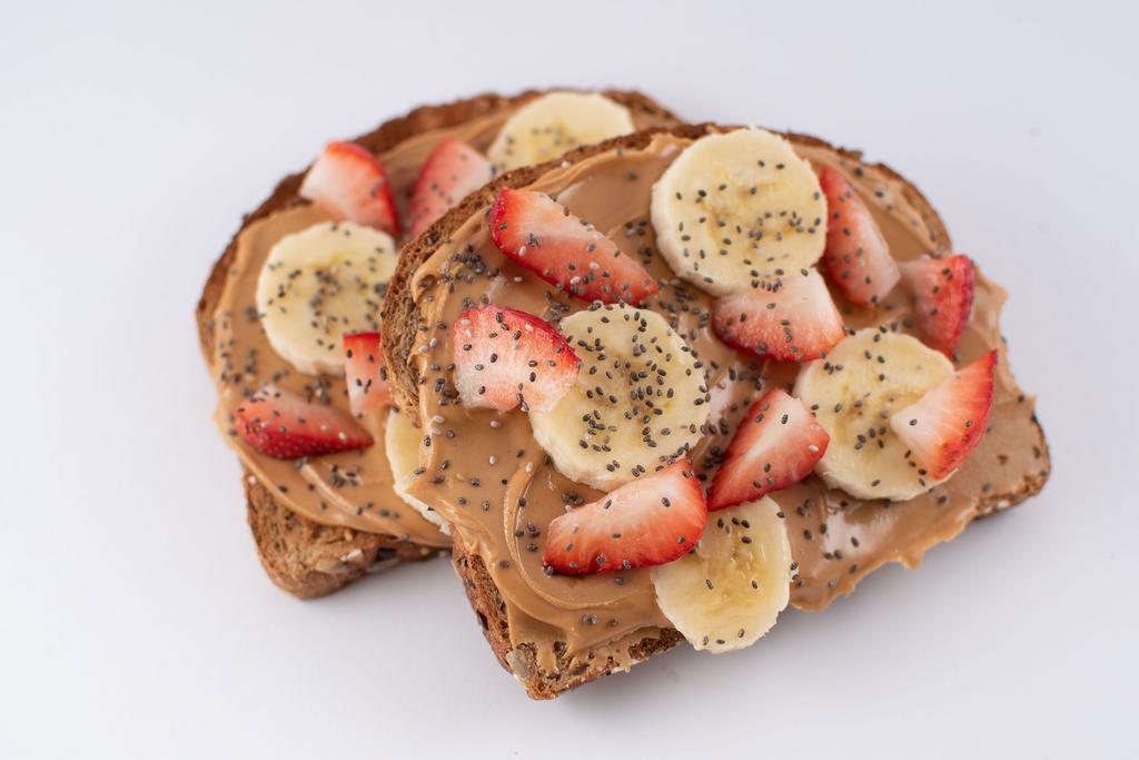 Peanut Butter Toast · 2 slices of organic whole-grain toast topped with natural peanut butter, your choice of strawberry, blueberry and banana, chia seed and your choice of a honey or agave drizzle.