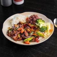 Mongolian Beef · Marinated ribeye stir-fried with onions, green onions, peppers and dried chili in savory sau...