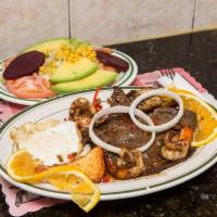 Bistec y Camarones · Steak and shrimp. Served with rice beans and salad.