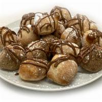 Nutella Bites · Baked to order dough bites smothered with Nutella and sprinkled with powdered sugar.