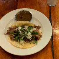 Barbacoa Taco · Slow-cooked beef.  All soft tacos served with onion, cilantro.  Crispy tacos served with pic...