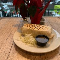 Chicken Chorizo Burrito · Spiced chicken sausage, scrambled eggs, rice, sour cream, cheese, refried beans and French f...