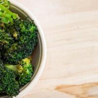 Oven Crisped Broccoli · Served with a side of Joe's house made goddess dressing.