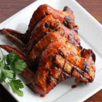 Rotisserie Buffalo Wings · Six whole wings rubbed with signature herbs and spices, roasted over an open flame and brush...