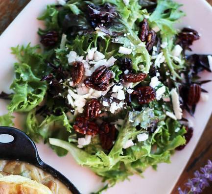 Mixed Greens · Maple candied pecans, ricotta salata, and honey citrus vinaigrette served on side.