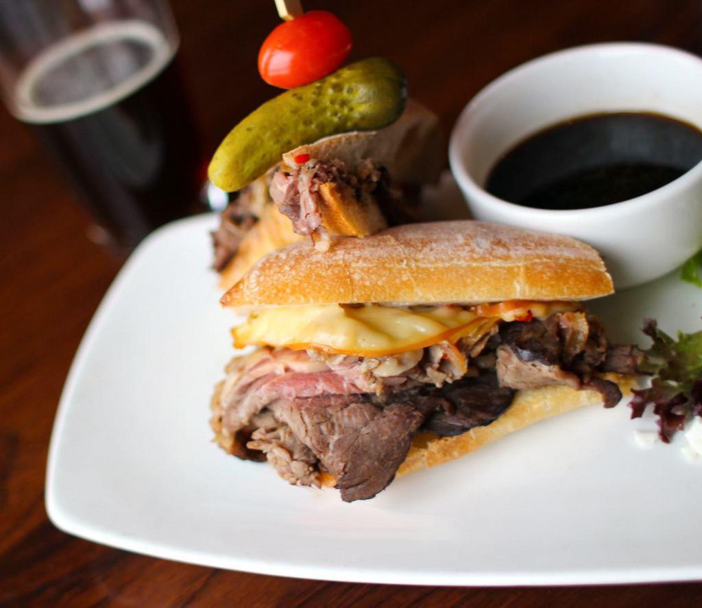Prime Rib Dip PC-Style Sandwich · Fire-roasted bell peppers, caramelized onions, and smoked gouda cheese, ciabatta.