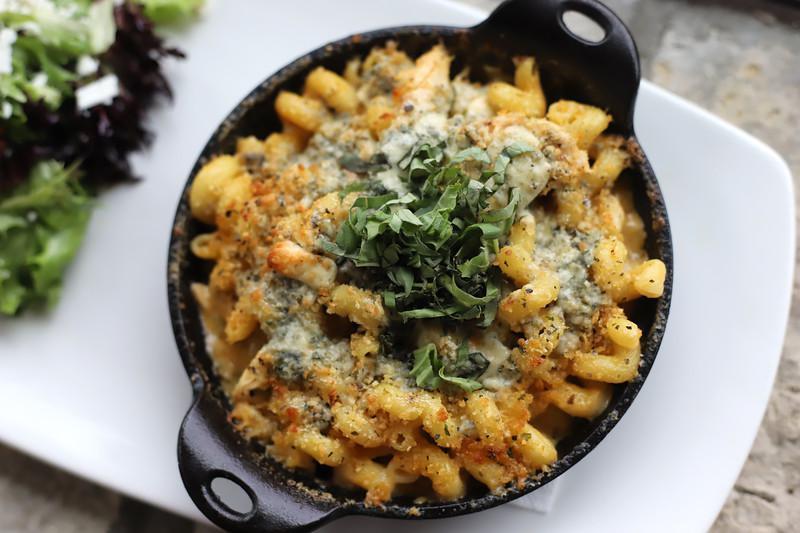 Buffalo Mac · Spicy Buffalo cream sauce, rotisserie chicken, toasted bread crumbs, blue cheese crumbles, and basil.
