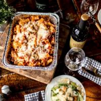 Rigatoni with Italian Sausage Family · Baked rigatoni with Italian sausage, caesar salad with dressing served on the side, loaf of ...