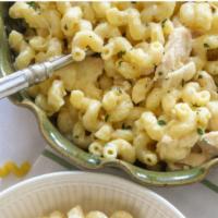 Parmesan Cream Pasta Family · Cavatappi tossed with rotisserie chicken, caesar salad with dressing on the side, loaf of it...