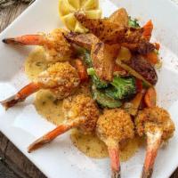 Gamberoni Oreganata · Jumbo shrimp served in oreganata style topped with toasted bread crumbs in a white sauce.