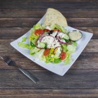 Greek Salad · Made with romaine lettuce and served with pita bread and dressing on the side. 