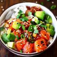 Salmon Poke Bowl · Sushi rice, lettuce, salmon, avocado, cucumber, seaweed salad, ginger, sesame seed and choic...