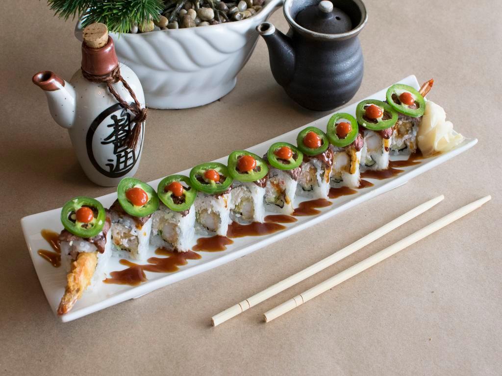 Surf and Turf Roll · Shrimp tempura with avocado and cucumber, topped with rib eye steak and jalapeno drizzled with sweet sauce and red chili sauce. Cooked and spicy.