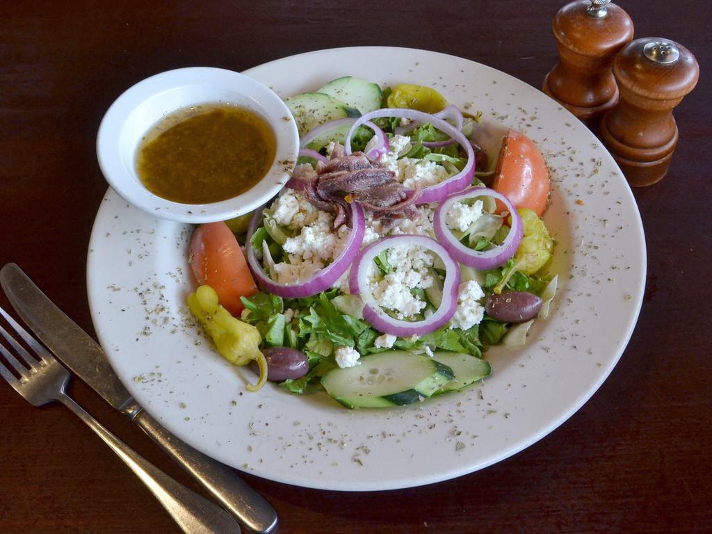 Greek Salad · Imported feta cheese and Kalamata olives, red onions, tomatoes, cucumbers, pepperoncini and anchovies, served with our homemade house vinaigrette dressing
