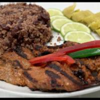 Lomo de Cerdo Asado · Charbroiled pork loin marinated with achiote and a special blend of spices.
