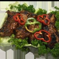 Costilla de Cerdo Asada · Charbroiled pork ribs.