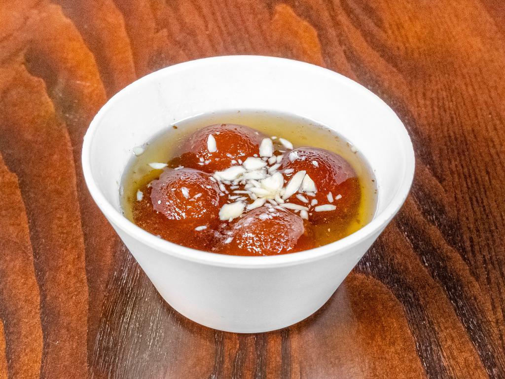 Gulab Jamun · Juicy milk dumplings dipped in honey syrup rice in thick milk with almonds, nuts and raisins.