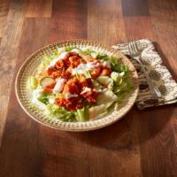 Buffalo Wing Salad · Mixed greens, tomatoes and cucumbers topped with a breaded chicken, tossed in our wing sauce...