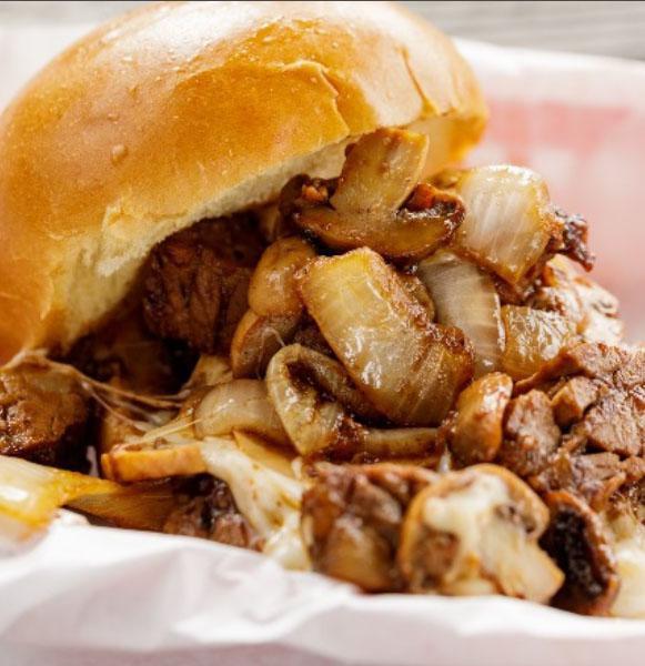 The Burnt Ends Steak Sandwich · Our delicious burnt ends covered in mozzarella cheese, grilled onions, mushrooms and steak sauce.