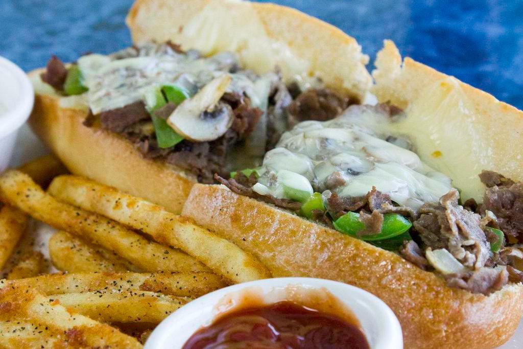 Philly Cheese and Steak Sandwich · Our famous Philly, smothered in American cheese, mayo. 

You may add sauteed peppers, onions, and mushrooms for an additional charge. 
Heavy steak for an additional charge.