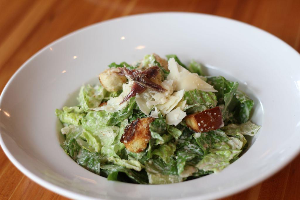 Caesar Salad · Romaine, Parmesan cheese and toasted basil croutons with Caesar dressing.