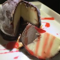 Vanilla and Chocolate Tartufo · Made with creamy premium ice cream centered with sliced nuts and a cherry, then coated in th...
