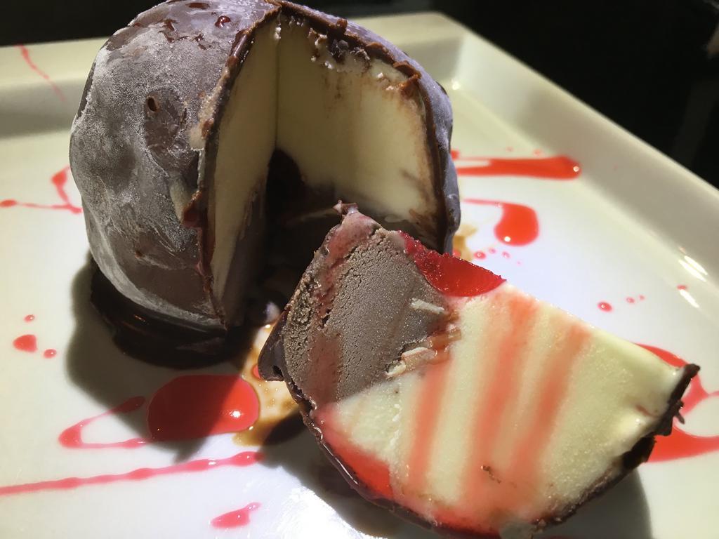 Vanilla and Chocolate Tartufo · Made with creamy premium ice cream centered with sliced nuts and a cherry, then coated in the finest bittersweet chocolate.