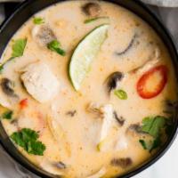 Coconut Chicken Soup · Sliced chicken, bell pepper, galangal and straw mushroom in coconut milk broth.