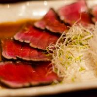Pepper Tuna Tataki · Slices of seared tuna with special pepper and served with lemon vinaigrette.