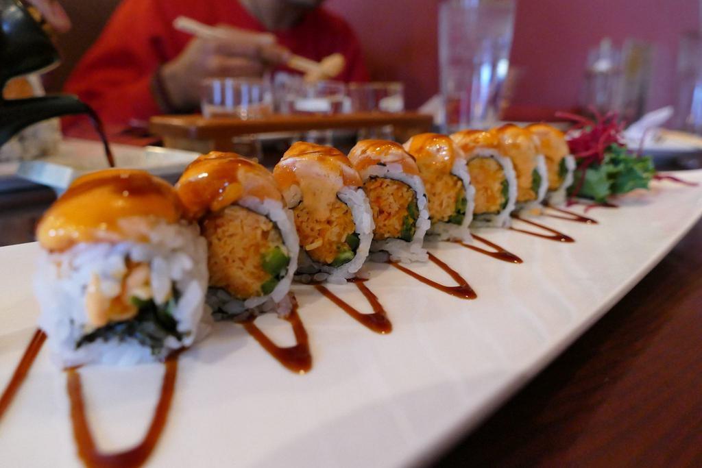 Hot Girl Roll · Spicy crab and jalapeno inside, topped with seared salmon tataki dressed in a slightly spicy sauce.