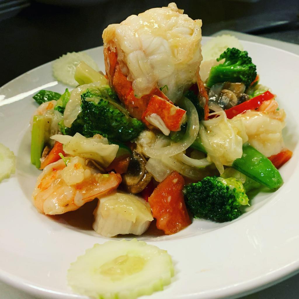 Seafood Trio Plate · Lobster tail, scallops, shrimp, veggie medley and garlic white wine sauce. Served with white or brown rice or fried rice. Gluten free.