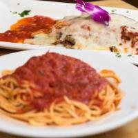 Eggplant Parmigiana · Lightly breaded skinless eggplant covered with tomato sauce and mozzarella cheese. Served wi...